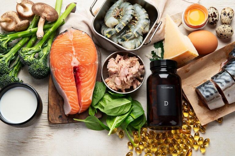 Vitamin D-rich foods and supplements displayed: salmon, eggs, mushrooms, shrimp, and vitamin D capsules