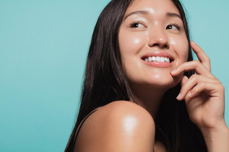 Vitamin B5 with woman glowing, dewy complexion showcases healthy skin against turquoise background