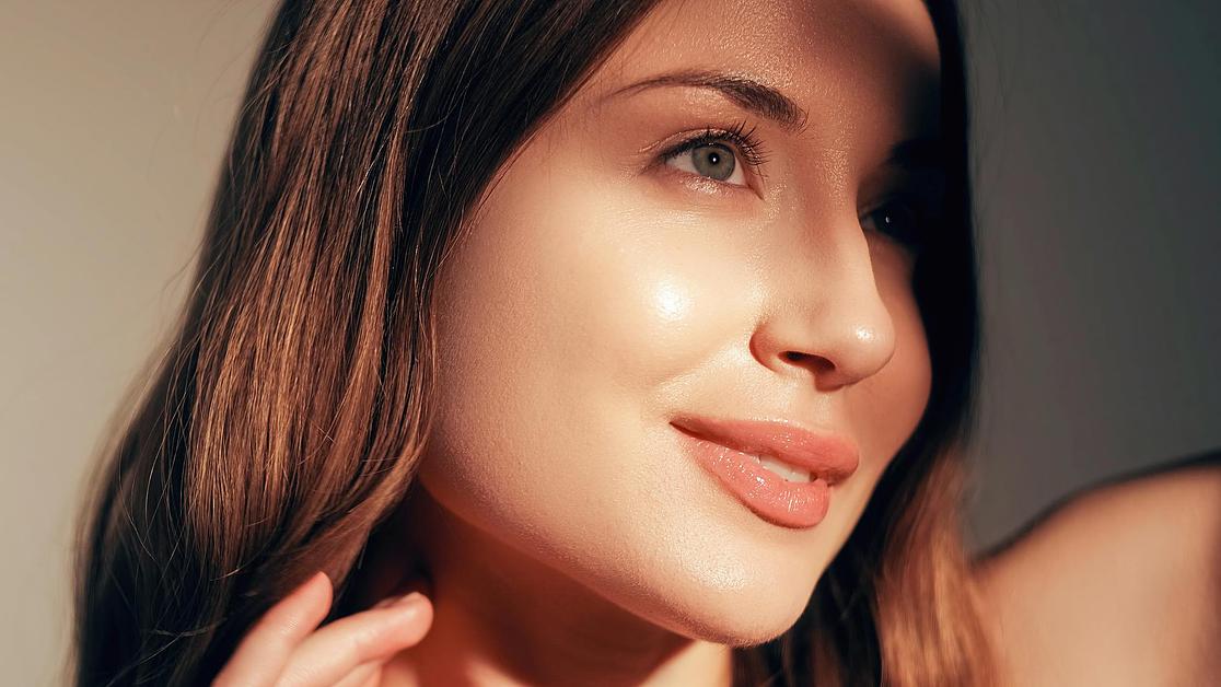 Vitamin D giving radiant healthy skin glowing in warm sunlight, showcasing natural beauty and a dewy, luminous complexion